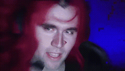 Red-Haired Man With Horn Looking at Camera