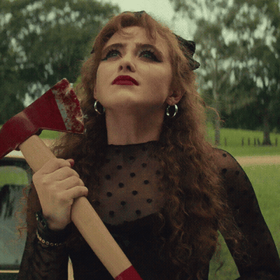 Red-Haired Woman Holding Bloody Axe GIF