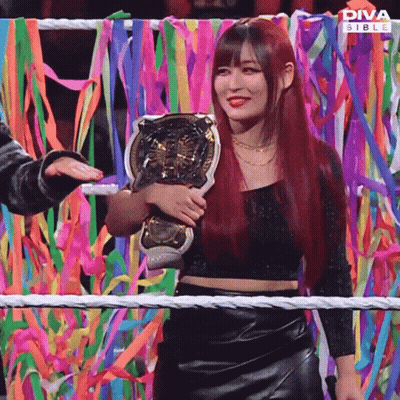 Red-Haired Woman Holding Diva Stable Trophy GIF