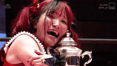 Red Haired Woman Holding Silver Trophy GIF