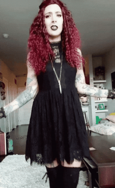 Red-Haired Woman In Black Dress And Boots GIF