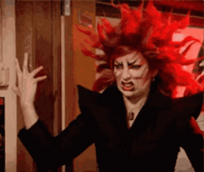 Red Haired Woman In Black Jacket Making Face GIF