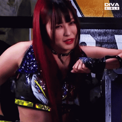 Red Haired Woman In Front Of Diva Bible Ad GIF