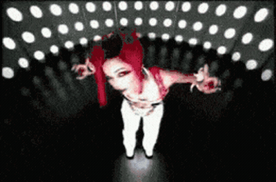 Red-Haired Woman In White Pants In Dark Room GIF