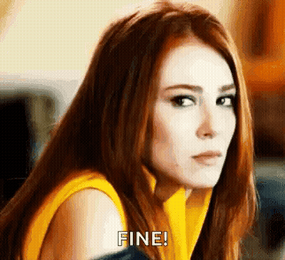 Red-Haired Woman In Yellow Shirt Making Face GIF
