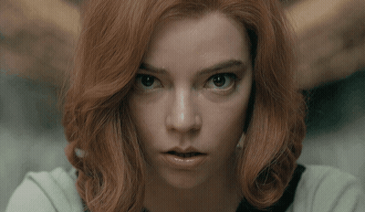 Red-Haired Woman Looking Seriously At Camera GIF