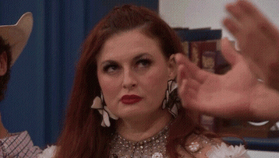 Red-Haired Woman Making Heart, Man In Cowboy Hat GIF