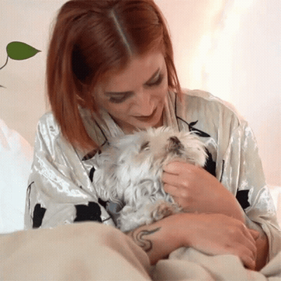 Red Haired Woman Petting Small White Dog GIF