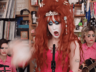 Red-Haired Woman Singing Into Microphone With Crown GIF