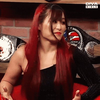 Red-Haired Woman Sitting At Diva Bible Sign GIF