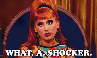 Red-Haired Woman Sitting In Chair Saying What A Shocker GIF