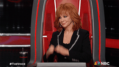 Red-Haired Woman Sitting In NBC Chair GIF