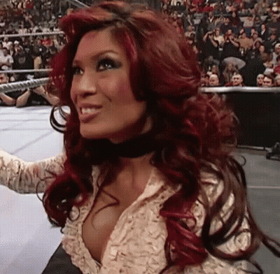 Red-Haired Woman Smiling Before Crowd GIF