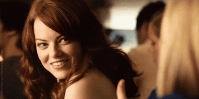 Red-Haired Woman Smiling Over Shoulder At Man GIF