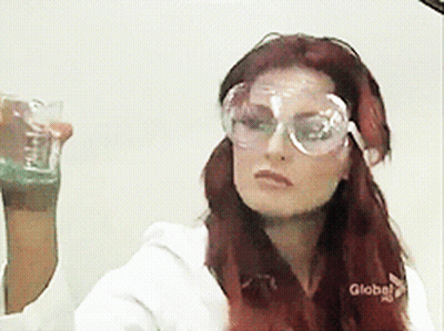 Red-Haired Woman Wearing Goggles Holding Glass GIF