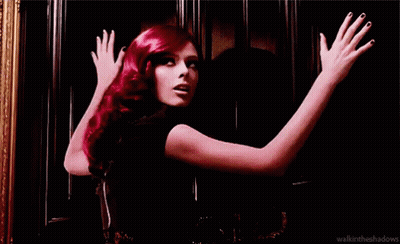 Red-Haired Woman With Arms Outstretched At Door GIF