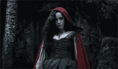 Red Hooded Woman Standing In Dark GIF