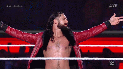 Red Jacket Wrestler Arms Outstretched In Ring GIF