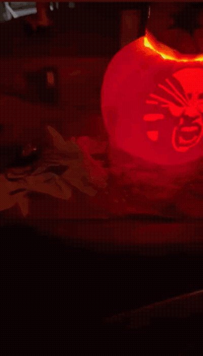 Red Lantern With Chinese Writing Lit Up In Dark GIF