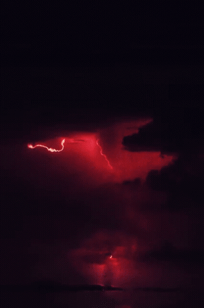 Red Lightning Bolt Striking Ground In Dark GIF