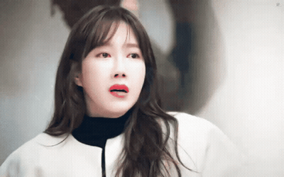Red-Lipped Woman In White Jacket And Black Turtleneck GIF