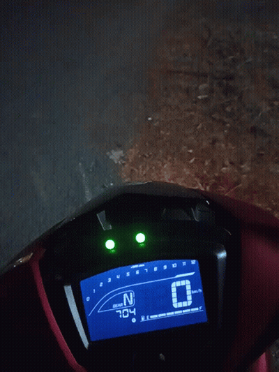Red Motorcycle Digital Display Showing 1:25 GIF