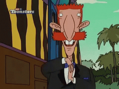 Red Mustache Tuxedo Character Standing In Front Of Toonsters Building GIF