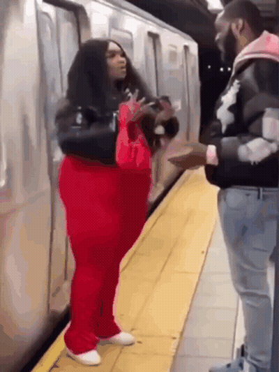 Red Pants Woman Talking To Black Jacket Man GIF