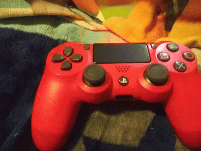 Red PlayStation Controller On Blanket GIF