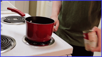 Red Pot On Stove Next To Soup Can GIF