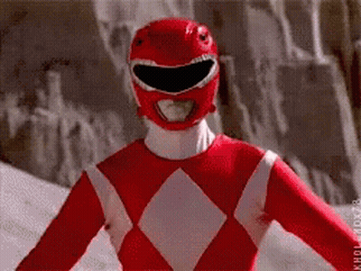 Red Power Ranger Smiling In Front Of Rock Wall GIF