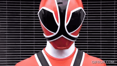 Red Power Ranger Standing In Front Of Brick Wall GIF