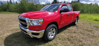 Red Ram Truck Parked On Grassy Field GIF