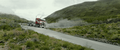 Red Semi Truck Driving On Mountain Road GIF