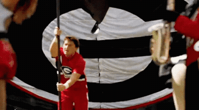Red Shirt Man Holding Flag With Letter G GIF