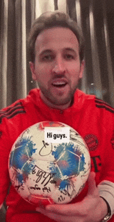 Red Shirt Man Holding Signed Soccer Ball Saying Hi Guys GIF