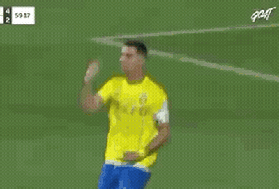 Red Shirt Referee Talking To Yellow Shirt Soccer Player GIF