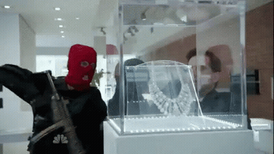 Red Ski Mask Man Looking At Necklace GIF