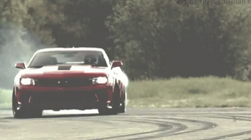 Red Sports Car Drifting On Track With Trees GIF