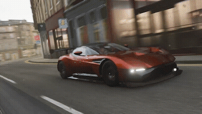 Red Sports Car Driving Down City Street GIF