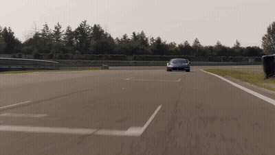 Red Sports Car Driving Down Road With White Line GIF