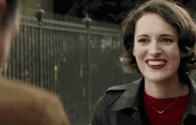 Red Sweater Black Coat Woman Smiling At Man GIF