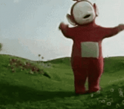 Red Teletubbies Standing In Grass GIF