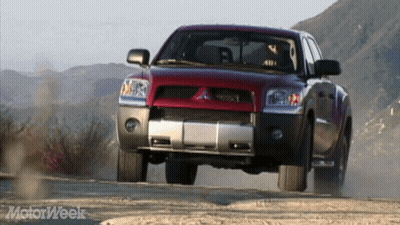 Red Truck Driving Down Dirt Road Motorweek GIF