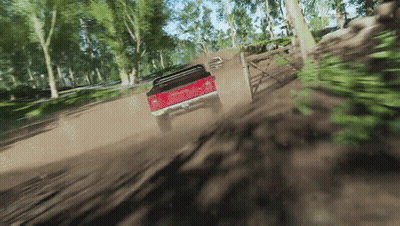Red Truck Driving Down Dirt Road With Trees GIF
