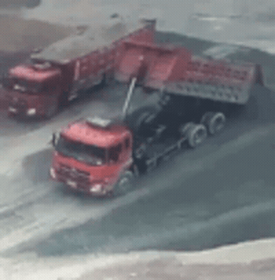 Red Trucks Parked On Dirt Road GIF