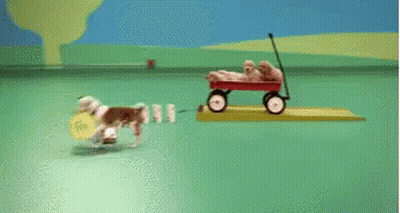 Red Wagon Filled With Puppies On Green Surface GIF