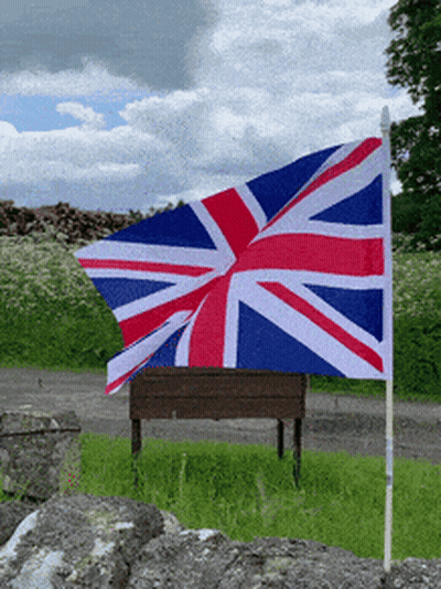 Red White And Blue British Flag Flying In Field GIF