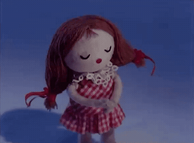 Redhead Doll In Checkered Dress Eyes Closed GIF