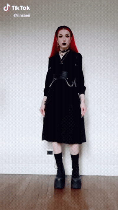 Redhead Girl in Black Dress and Platform Boots